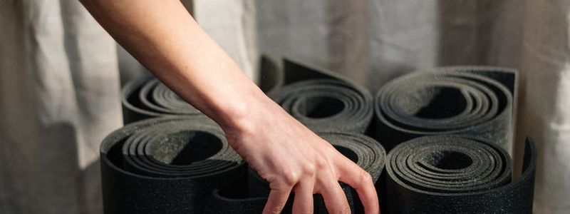 Wide shot of a clean minimal yoga studio with mats